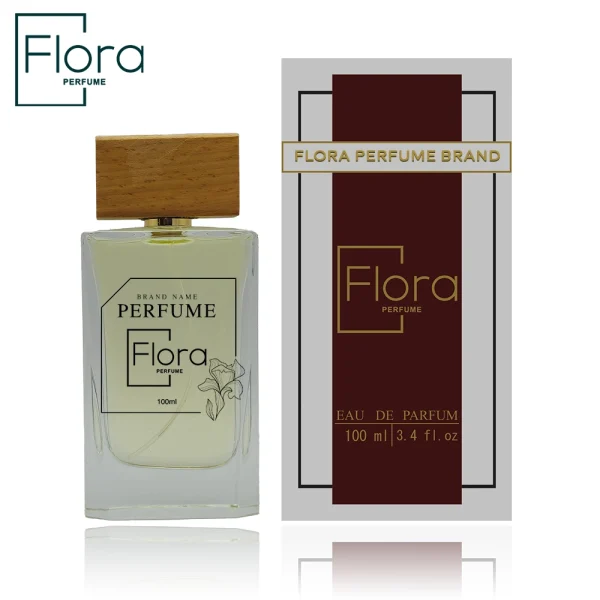 تصویر شامل یک بطری عطر و جعبه آن با طراحی زیبا مربوط به برند “Flora Perfume” است. بطری عطر شفاف بوده و دارای درپوش چوبی است. روی بطری، نام برند و جزئیاتی مانند حجم محصول (100 میلی‌لیتر) و تصویر گل درج شده است. جعبه عطر در کنار بطری قرار گرفته و دارای رنگ‌بندی شیک (ترکیب قرمز تیره و طلایی) با متنی شامل نام برند و مشخصات محصول است. قسمت پایین تصویر دارای انعکاس شیشه‌ای است که جلوه بصری خاصی به طراحی داده است.